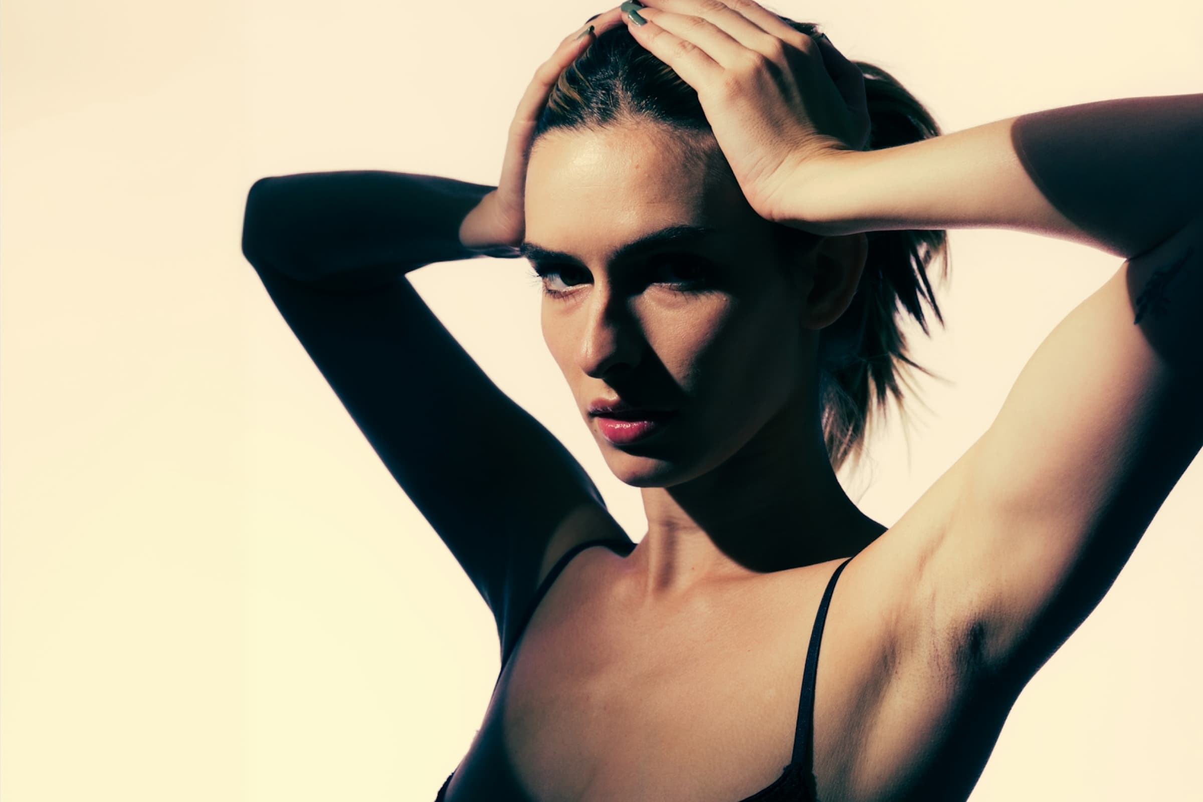 woman hands on her head